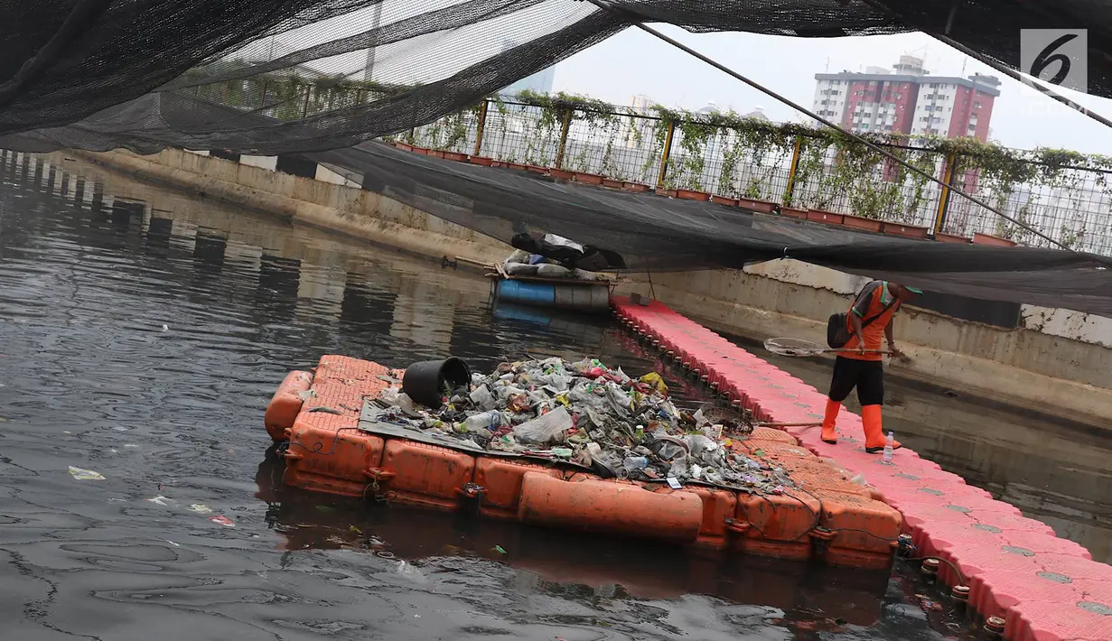 Petugas menjaring sampah plastik yang terbawa aliran air Kali Item di Jakarta, Minggu (4/11). Buruknya perilaku warga yang membuang sampah sembarangan menyebabkan sungai-sungai di Jakarta kerap dipenuhi sampah plastik. (Liputan6.com/Immanuel Antonius)