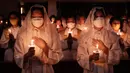 Umat Kristiani menjalani ibadah misa Tri Hari Suci jelang perayaan Paskah 2024. (Yasuyoshi CHIBA/AFP)