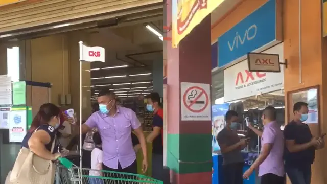 Seorang petugas keamanan periksa suhu tubuh pengunjung