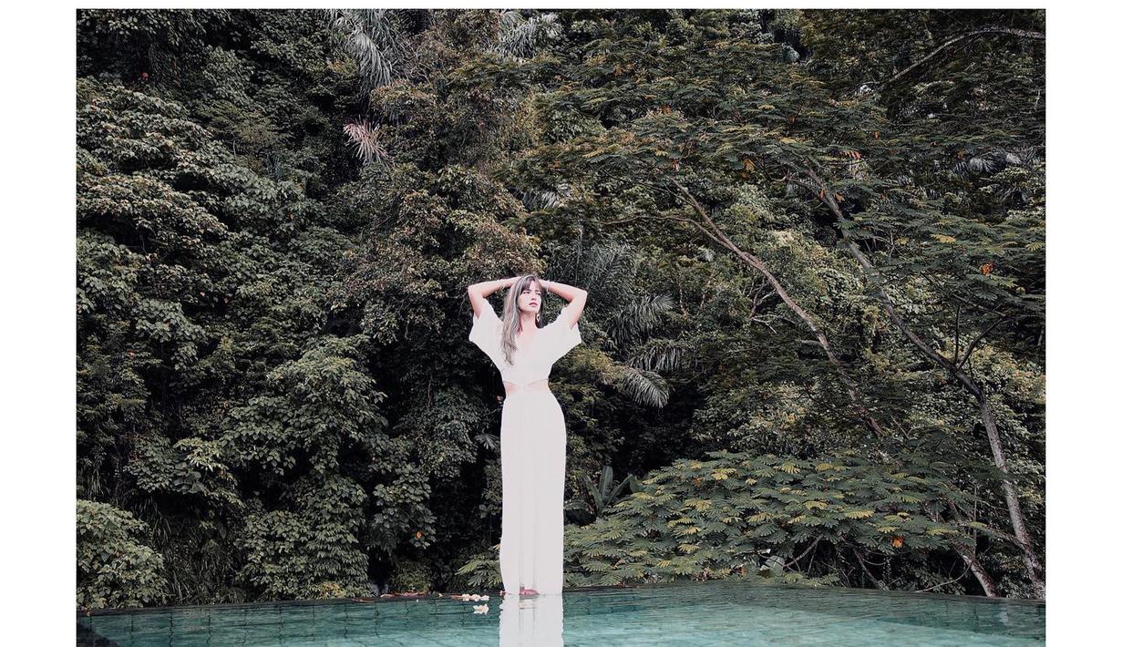 Saat berlibur di resort mewah seperti Mandapa Ritz Carlton Reserve yang menawarkan pemandangan hutan hujan dengan tanaman dan pepohonan serta kolam renang luar ruangan, Nia Ramadhani memilih maxi dress warna putih yang sleek dan sophisticated. (Foto: Instagram @ramadhaniabakrie)