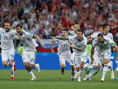 Pemain Rusia berselebrasi setelah sang kiper, Igor Akinfeev menahan tendangan penalti timnas Spanyol pada babak 16 besar Piala Dunia 2018 di Stadion Luzhniki, Minggu (1/7). Rusia lolos ke perempat final setelah menang adu penalti 4-3. (AP/Manu Fernandez)