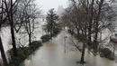 Taman bermain yang banjir di tepi sungai Seine di Paris (22/1). Sungai Seine telah berubah menjadi torrent berlumpur yang kuat yang telah menenggelamkan taman dan jalan. (AFP Photo/Stephane De Sakutin)