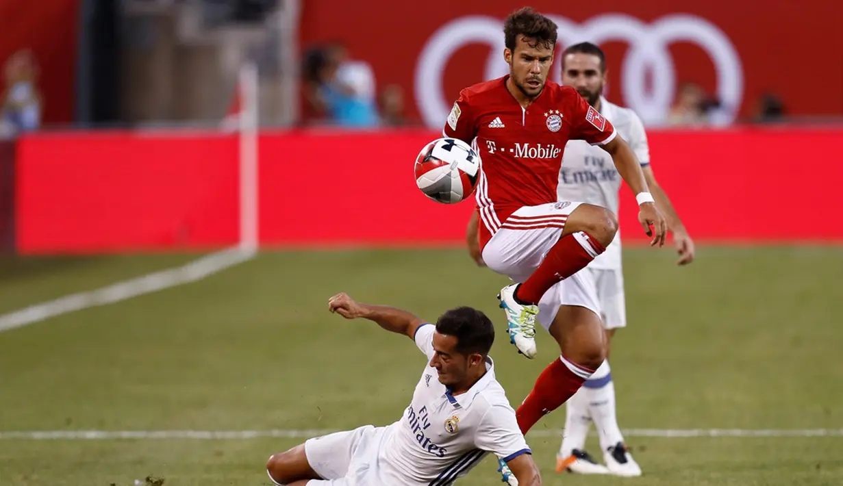 Pemain Real Madrid, Lucas Vasquez, berebut bola dengan pemain Bayern Munchen, Juan Bernat (kanan), pada laga lanjutan International Champions Cup 2016 di MetLife Stadium, New Jersey, AS, Kamis (4/8/2016) pagi WIB. (AFP/Jeff Zelevansky/Getty Images)