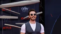 Aktor AS Chris Evans berpose di karpet merah untuk Pemutaran Khusus Netflix "The Grey Man" di bioskop Zoo Palast di Berlin pada 18 Juli 2022. Pemeran Captain America di Marvel Cinematic Universe itu mewarisi gelar Pria Terseksi tersebut dari Avenger lainnya, Paul Rudd. (AFP/DAVID GANNON)