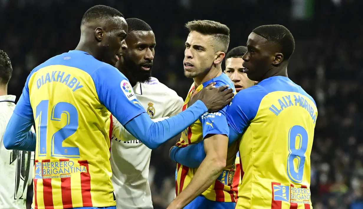 Sejumlah pemain berusaha menenangkan pemain Valencia, Gabriel Paulista saat melawan Real Madrid pada laga Liga Spanyol di Stadion Santiago Bernabeu, (2/2/2023). Los Blancos mampu menang 2-0 atas Valencia di Santiago Bernabeu. (AFP/Javier Soriano)
