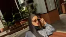 Jinjing tas Chanel merah, Paula kenakan setelan kemeja dan celana abu-abu satin. Dipadu dengan hijab lilit hitam dan sunglasses [@paula_verhoeven]