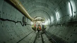 Seorang pekerja berjalan di ujung lokasi pembangunan terowongan dengan mesin bor terowongan untuk proyek Mass Rapid Transit (MRT) Fase 2, yang akan memperpanjang jalur saat ini ke arah utara dengan dana pinjaman dari Japan International Cooperation Agency (JICA), di Jakarta pada tanggal 7 Mei 2024. (Yasuyoshi CHIBA/AFP)