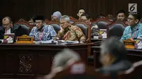 Ekspresi Ketua KPU Arief Budiman (tengah) saat mengikuti sidang sengketa Pilpres 2019 di Gedung MK, Jakarta, Selasa (18/6/2019). Sidang tersebut beragendakan mendengarkan jawaban dari termohon. (Liputan6.com/Faizal Fanani)