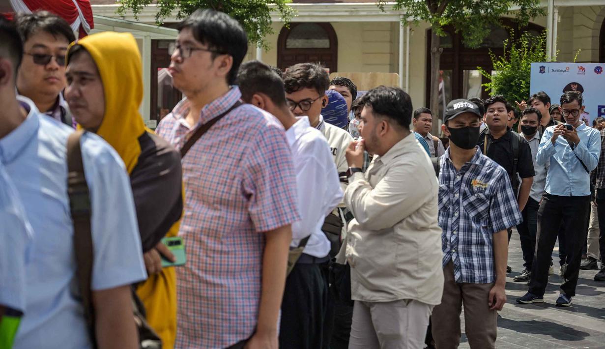 Sebagai informasi, berdasar laporan BPS per 5 Februari 2026, jumlah pengangguran di Indonesia per November 2025 tercatat sebanyak 7,35 juta orang, atau turun 0,109 juta dibanding Agustus 2025. Tampak dalam foto, para pencari kerja mengantre untuk mendaftar di salah satu event bursa kerja, Surabaya, Jawa Timur pada Selasa 7 April 2026. (JUNI KRISWANTO/AFP)