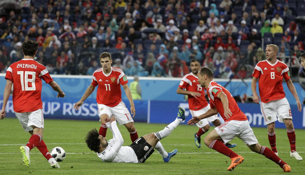 Gelandang Mesir, Mohamed Salah, terjatuh saat melawan Rusia, pada laga Grup A Piala Dunia di Stadion Krestovsky, St Petersburg, Selasa (19/6/2018). Rusia menang 3-1 atas Mesir. (AP/Gregorio Borgia)
