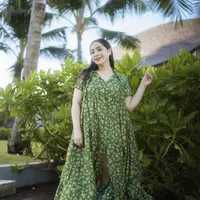 Nagita Slavina tampil elegan mengenakan dress panjang warna hijau army dengan motif bunga-bunga warna kuning. Credit: Instagram (@raffinagita1717)