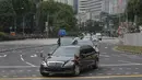 Iring-iringan mobil yang diyakini membawa pemimpin Korea Utara Kim Jong-un melewati Orchard Road menuju St Regis Hotel di Singapura, Minggu (10/6). Kedatangan Kim menjelang pertemuan bersejarah dengan Donald Trump pada Selasa mendatang. (AP/Joseph Nair)