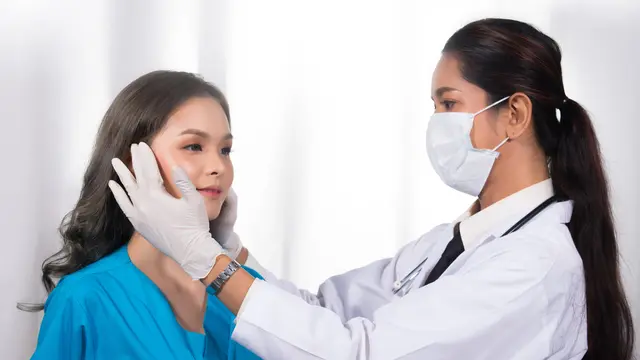 Seorang dokter sedang memeriksa kondisi pasien