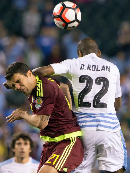 Penyerang Uruguay, Diego Rolan (kanan) berebut bola udara dengan gelandang Venezuela,  Alexander Gonzalez pada Copa America  Centenario 2016 di Lincoln Financial Field, AS (10/6). Venezuela menang atas Uruguay 1-0. (Bill Streicher-USA TODAY Sports)
