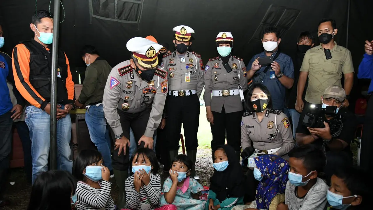 Korlantas Polri yang diwakili oleh Direktur Lalu Lintas (Dirlantas) Polda Jawa Tengah (Jateng) Kombes Pol Rudy Safirudin memberikan bantuan dan trauma healing bagi anak-anak korban erupsi Gunung Merapi. (Dok: Korlantas Polri)