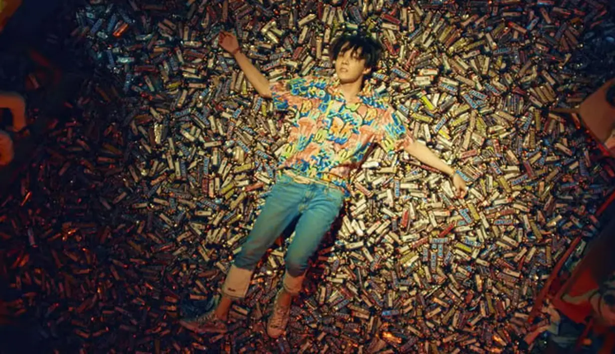 Dalam MV Fakve Love, terdapat satu scene yang memperlihat J-Hope sedang tidur di atas tumpukan cokelat. Ternyata scene ini menarik perhatian beberapa perusahaan cokelat di dunia. (Foto: Yooutube.com)