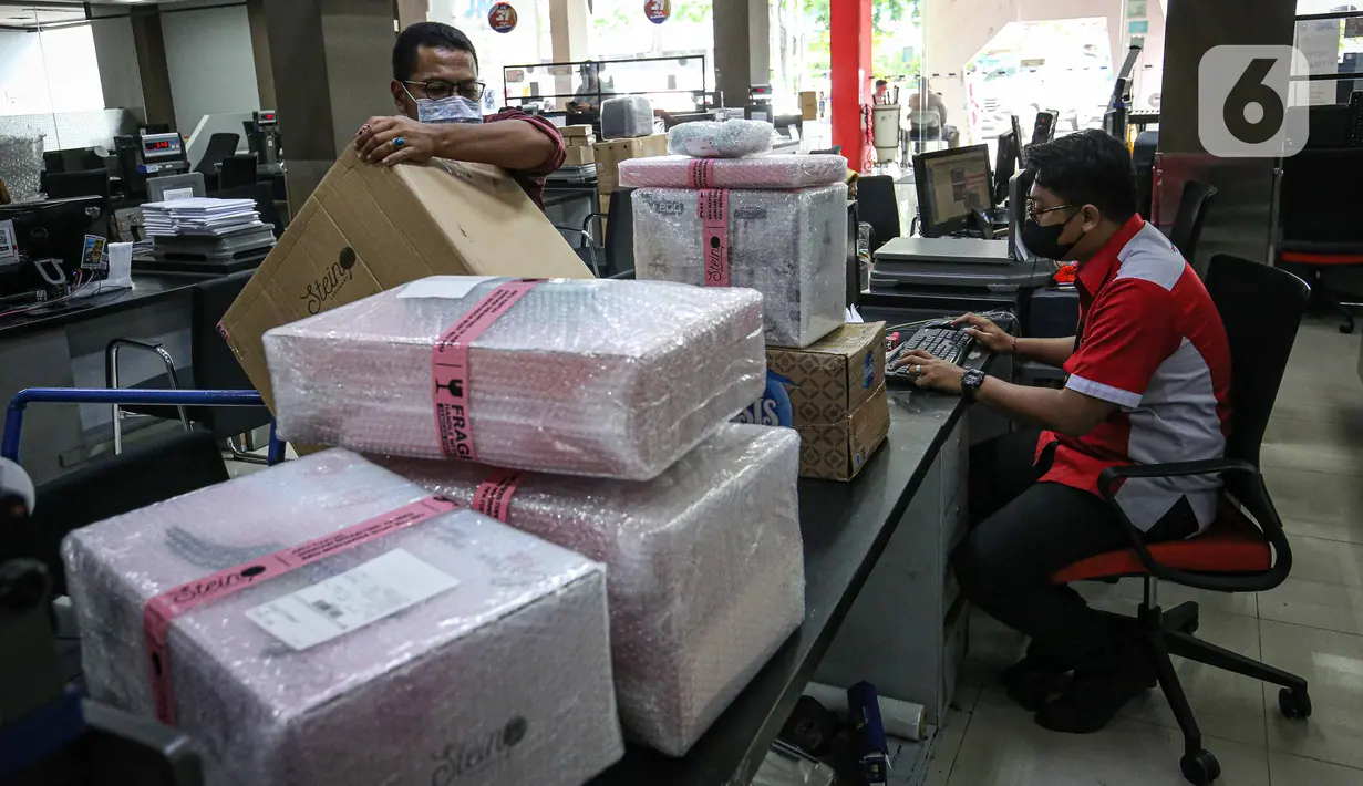Petugas ekspedisi melayani pengiriman paket pelanggan (kiri) di Kantor Cabang JNE, Jakarta, Kamis (30/12/2021). Supply Chain Indonesia (SCI) memprediksi peningkatan pengiriman barang pada akhir tahun ini mencapai 20 persen untuk ke wilayah luar Pulau Jawa dan Bali. (Liputan6.com/Faizal Fanani)