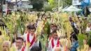 Minggu Palma sering dirayakan dengan drama perjalan Yesus memasuki Kota Yerusalem atau proses yang menyentuh hati. (Ted ALJIBE/AFP