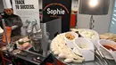 Robot koki bernama Sophie meracik semangkuk laksa saat demonstrasi memasak di Singapura pada 26 Juli 2019. Inovasi robot penyaji makanan ini bakal semakin populer dan menjadi stasiun masak otomatis yang umum dipakai di Singapura.  (Roslan RAHMAN / AFP)