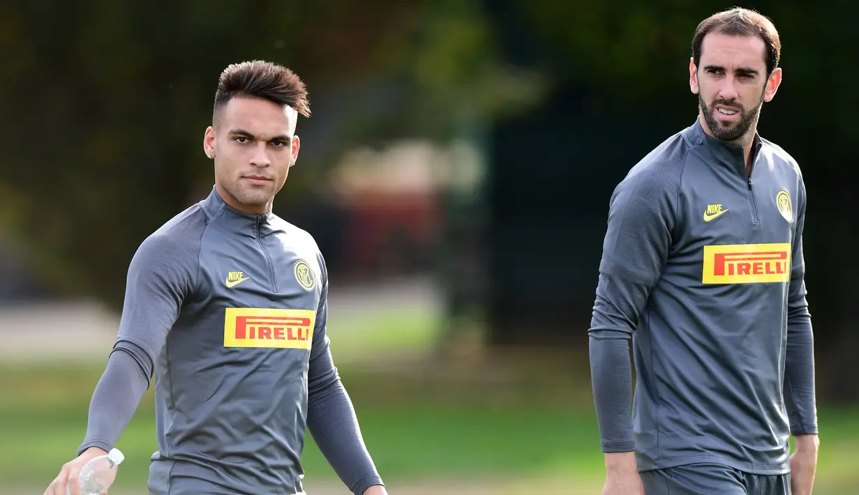 Pemain depan Inter Milan Lautaro Martinez (kiri) dan bek Diego Godin tiba menghadiri sesi latihan di pusat pelatihan Suning di Appiano Gentile, Como, Italia (22/10/2019). Inter Milan akan bertanding melawan wakil Jerman, Borussia Dortmund pada grup F Liga Champions. (AFP/Miguel Medina)