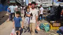 Orang-orang membeli produk segar di sebuah pasar di kota Gaza, pada 10 Oktober 2023. (Mohammed ABED / AFP)