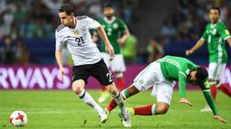 Striker Jerman, Sebastian Rudy, melewati bek Mexico, Rafael Marquez, pada laga semifinal Piala Konfederasi di Stadion Fisht, Sochi, Kamis (29/6/2017). Jerman menang 4-1 atas Mexico. (EPA/Peter Powell)