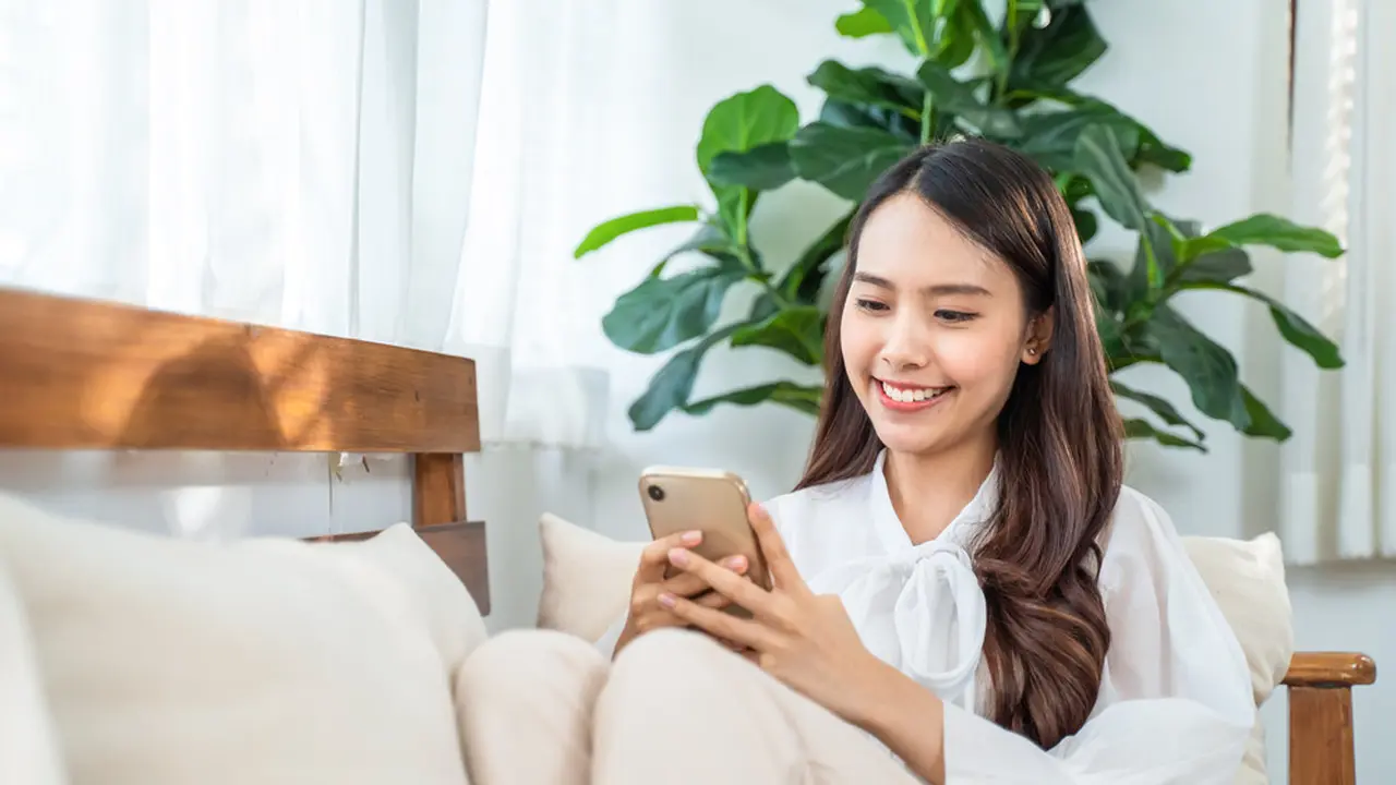 Perempuan bermain handphone