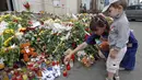 Penduduk setempat menyalakan lilin untuk para korban Malaysia Airlines MH-17 di luar kedutaan Belanda di Kiev, (19/7/2014). (REUTERS/Valentyn Ogirenko) 