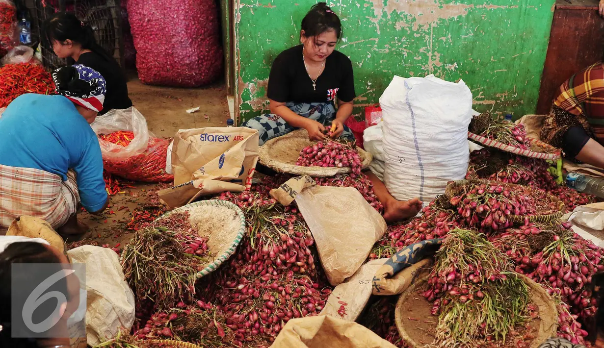 Pekerja tengah mengupas bawang merah di Pasar Kramatjati, Jakarta, Selasa (8/3). Harga bawang merah mengalami kenaikan hingga 40 persen. kenaikan harga hingga Rp 45 ribu per kg yang sebelumnya seharga Rp30 ribu per kg. (Liputan6.com/Angga Yuniar)