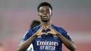 Pemain Arsenal, Bukayo Saka, melakukan selebrasi usai mencetak gol ke gawang Southampton pada laga Liga Inggris di Stadion St Mary, Selasa (26/1/2021). Arsenal menang dengan skor 3-1. (AP/Frank Augstein, Pool)
