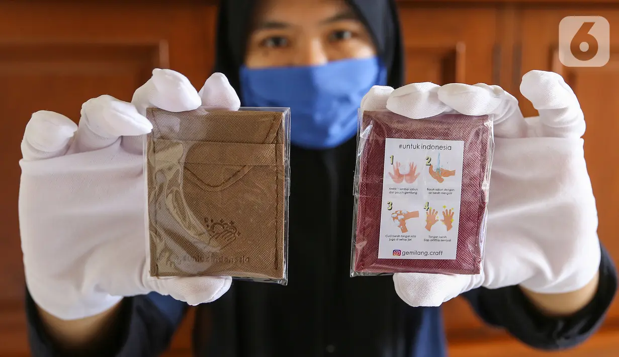 Pekerja menunjukkan pouch gemilang berisikan sabun cuci tangan berukuran kertas di Gemilang Craft Pamulang, Tangerang Selatan, Kamis (23/4/2020). Sebagian hasil penjualan produksi yang telah mencapai 2000 buah tersebut di donasikan dalam bentuk sembako dan baju hazmat. (Liputan6.com/Fery Pradolo)