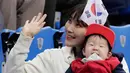 Penggemar wanita Korea Selatan menantikan dimulainya pertandingan speedskating 500 meter putri selama Olimpiade Musim Dingin 2018 di Gangneung, Korea Selatan, Selasa, (13/2). (AP Photo / Julie Jacobson)