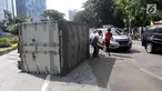 Sebuah mobil boks terguling di Jalan Casablanca, Jakarta, Rabu (27/6). Mobil bernomor polisi B 9515 FCC terguling setelah menabrak pembatas jalan. (Liputan6.com/Arya Manggala)