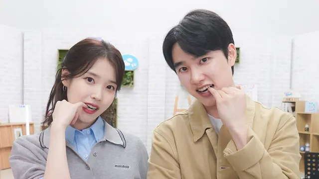 IU dan D.O atau Doh Kyung Soo tampil bersama nyanyikan lagu Love Wins All. (Tangkapan Layar Youtube IU)