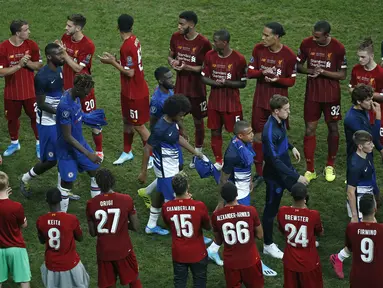 Pemain Chelsea berjalan di depan pemain Liverpool untuk mendapatkan medali setelah pertandingan Piala Super Eropa 2019 di Besiktas Park, di Istanbul (15/8/2019). Chelsea kalah lewat adu penalti atas Liverpool 5-4 (2-2). (AP Photo/Emrah Gurel)