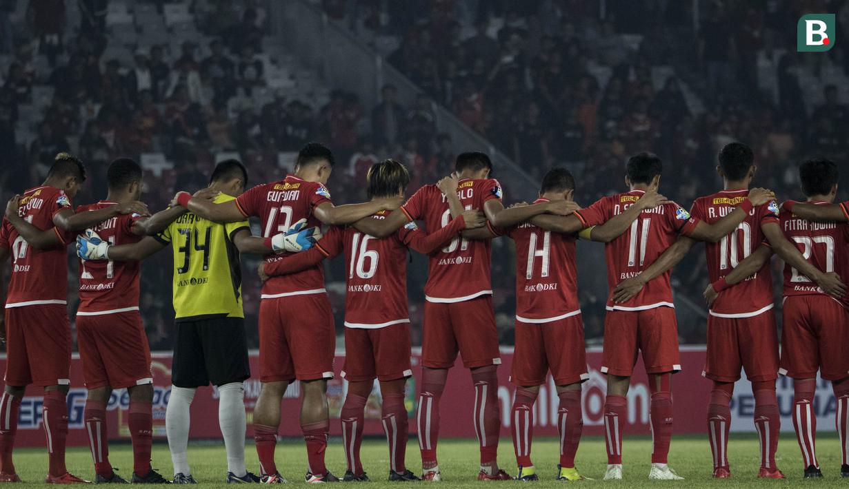 Para pemain Persija Jakarta mengheningkan cipta mengenang almarhum Zulkarnain Lubis sebelum melawan Madura United pada laga Liga 1 di SUGBK, Jakarta, Sabtu (12/5/2018). Persija kalah 0-2 dari Madura United. (Bola.com/Vitalis Yogi Trisna)