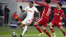 Pemain RB Leipzig, Christopher Nkunku, berusaha melewati pemain Liverpool pada laga Liga Champions di Puskas Arena, Kamis (11/3/2021). Liverpool menang dengan skor 2-0. (AP/Laszlo Balogh)