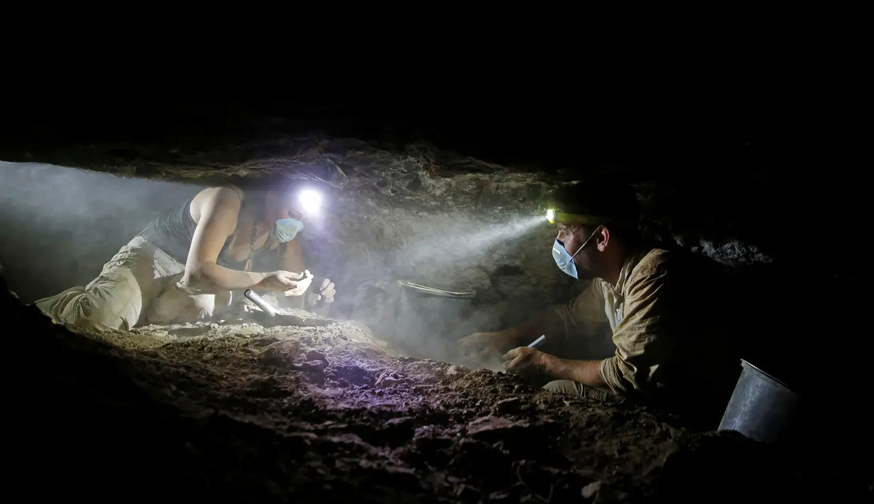 Tim relawan dan arkeolog dari Israel Antiquities Authority (IAA) saat mencari barang-barang bersejarah di gua tengkorak, Gurun Yudea, Israel, Rabu (1/6). Para arkeolog mencari sisa-sisa Gulungan Laut Mati yang tersembunyi di gua. (REUTERS / Ronen Zvulun)