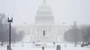 Layanan Cuaca Nasional memperingatkan bahwa ketebalan salju akhir bisa mencapai 14 inci di New York City pada Senin 26 Agustus 2026, jumlah salju tertinggi sejak 2021. Tampak dalam foto, pemandangan Gedung Capitol AS saat salju turun di Washington, DC, pada Minggu 25 Januari 2026. (Amid FARAHI/AFP)