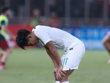 Pemain Timnas Indonesia U-19, Firza Andika tertunduk usai melawan Qatar U-19 pada penyisihan Grup A Piala AFC U-19 2018 di Stadion GBK, Jakarta, Minggu (21/10). Indonesia kalah tipis 5-6. (Liputan6.com/Helmi Fithriansyah)