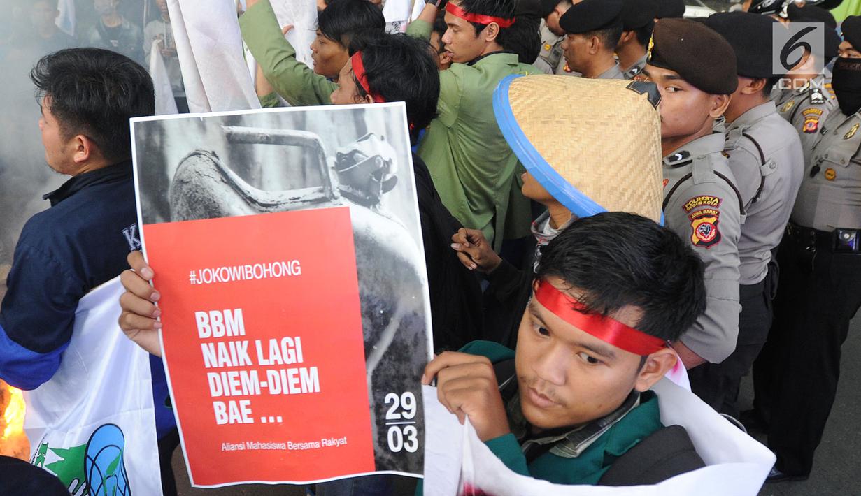 Seorang mahasiswa yang tergabung dalam Kesatuan Aksi Mahasiswa Muslim Indonesia (KAMMI) Bogor menunjukkan poster saat melakukan aksi di Jalan Ir. H.Djuanda, Bogor (29/03). Dalam akisnya mereka menolak harga kenaikan BBM. (Merdeka.com/Arie Basuki)