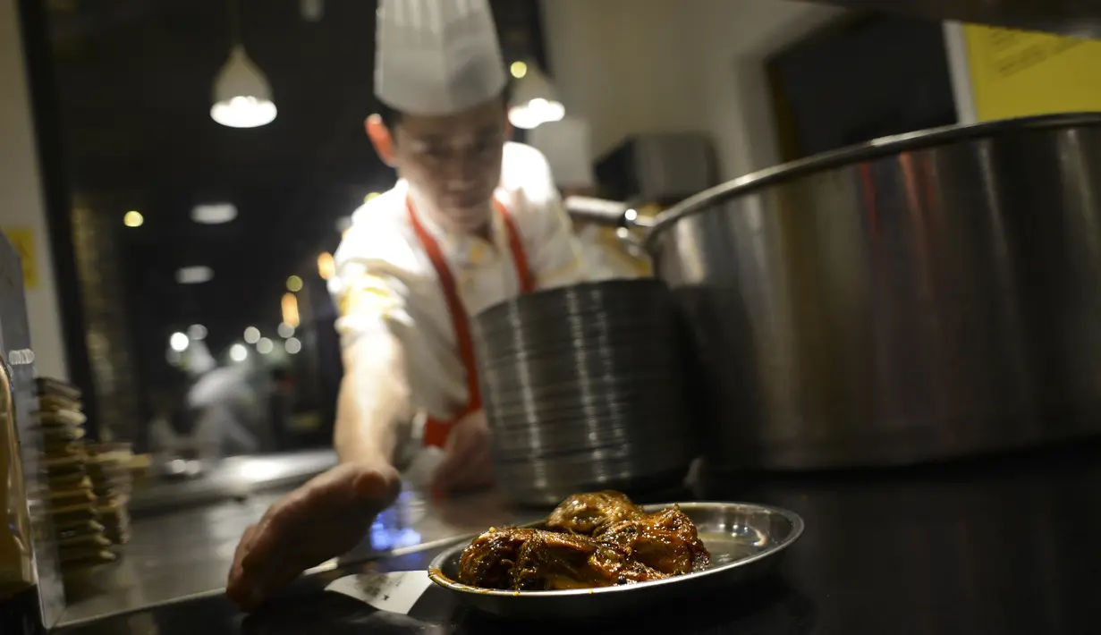 Koki menghidangkan sepiring menu kepala kelinci di sebuah restoran di Chengdu, ibu kota Provinsi Sichuan di barat daya China, 8 September 2016. Otak kelinci di negeri tirai bambu ini menjadi salah satu menu favorit warga lokal maupun asing (WANG ZHAO/AFP)