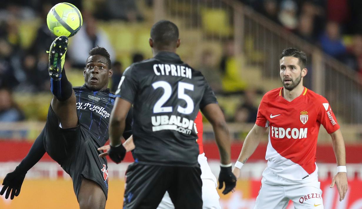 Aksi penyerang Nice, Mario Balotelli (kiri) menahan bola saat timnya melawan AS Monaco pada lanjutan Ligue 1 di Louis II Stadium, Monaco, (16/1/2018). AS Monaco bermain imbang 2-2 dengan Nice. (AFP/Valery Hache)