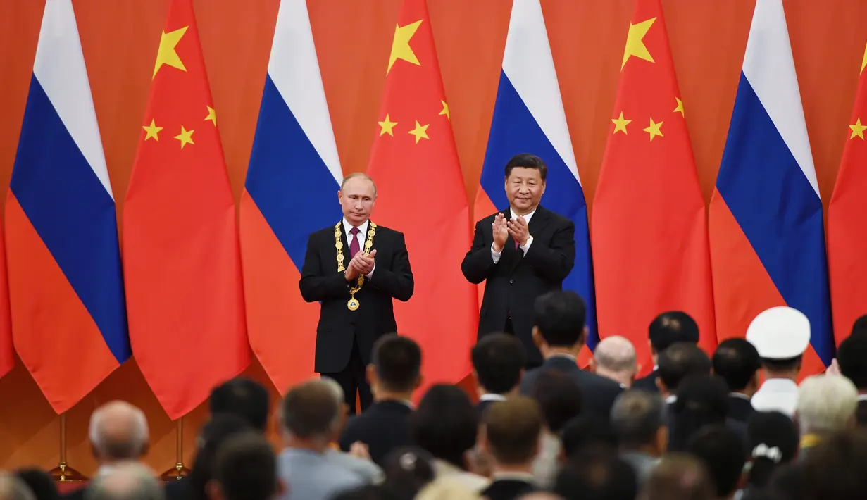 Presiden China Xi Jinping dan Presiden China Xi Jinping bertepuk tangan usai penyerahan Medali Persahabatan di Aula Besar Rakyat di Beijing, China (8/6). (AFP/Pool/ Greg Baker)