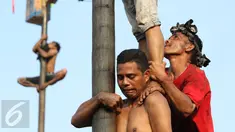 Peserta mengikuti lomba panjat pinang di Taman Impian Jaya Ancol, Jakarta, Rabu (17/8). Sebanyak 171 batang pohon pinang disiapkan panitia dalam rangka memeriahkan Hari Kemerdekaan RI yang ke-71. (Liputan6.com/Immanuel Antonius)