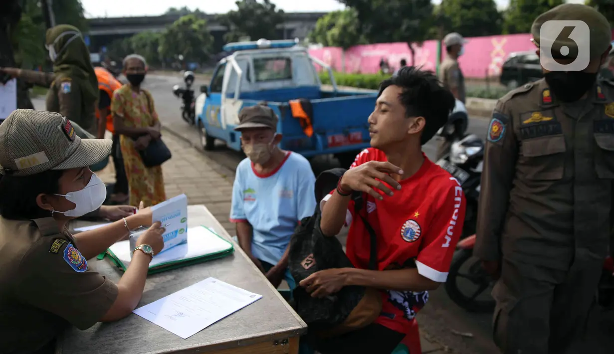 <p>Petugas Satpol PP mendata pelanggar saat melakukan razia masker di depan Stasiun Klender, Jakarta, Selasa (10/5/2022). Pemerintah memastikan akan terus memperpanjang masa pemberlakuan pembatasan kegiatan masyarakat (PPKM) se-Indonesia hingga waktu yang belum ditentukan. (Liputan6.com/Faizal Fanani)</p>