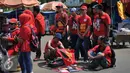 Buruh memilih kaos saat demo memperingati hari lahirnya organisasi buruh internasional World Federation of Trade Unions (WFTU) di Jakarta (3/10/2015).  Sejumlah PKL memanfaatkan demo buruh untuk meraup sedikit keuntungan. (Liputan6.com/Gempur M Surya)