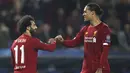 Penyerang Liverpool, Mohamed Salah (kiri)berselebrasi bersama rekannya Virgil van Dijk  usai mencetak gol ke gawang KRC Genk pada pertandingan lanjutan Grup E Liga Champions di Luminus Arena, Genk (23/10/2019). Liverpool menang telak -14 atas KRC Genk. (AP Photo/Francisco Seco)