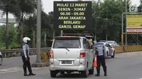 Petugas Dishub memberi informasi kepada pengendara mobil di depan Gerbang Tol Bekasi Barat 1, Bekasi, Jawa Barat, Senin (12/3). Penerapan ganjil-genap hanya berlaku pada dua pintu tol tersebut untuk arah Bekasi ke Jakarta. (Liputan6.com/Arya Manggala)