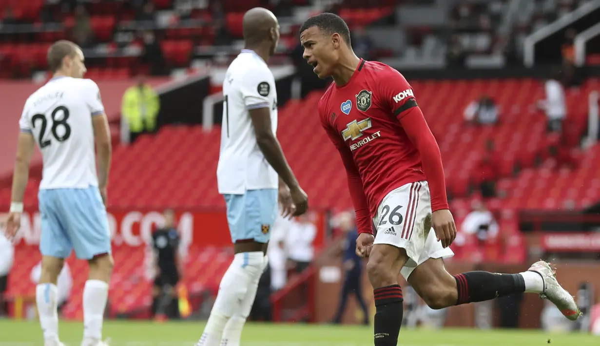 Pemain Manchester United, Mason Greenwood, melakukan selebrasi usai mencetak gol ke gawang West Ham United pada laga Premier League di Stadion Old Trafford, Rabu (22/7/2020). Kedua tim bermain imbang 1-1. (Cath Ivill/Pool via AP)